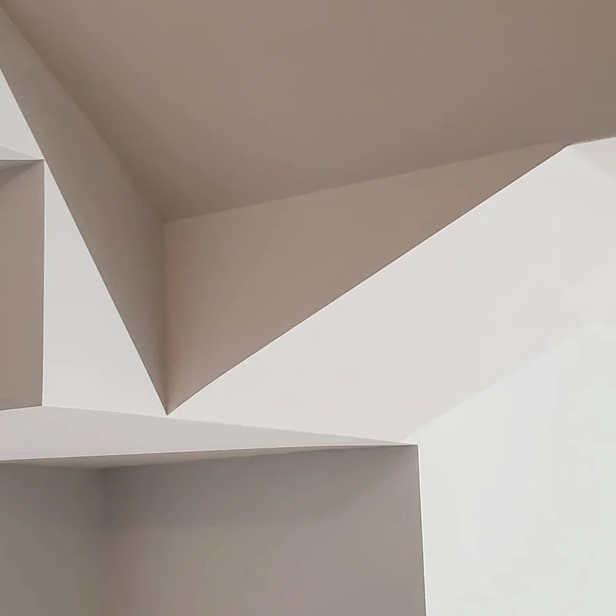 Smooth intersecting ceiling planes and crisp drywall corners.