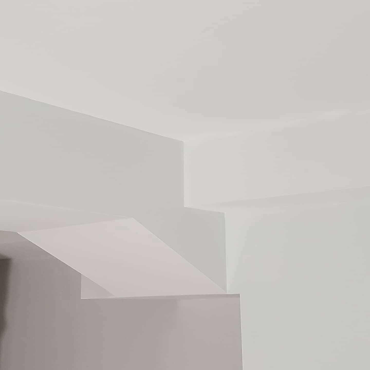 Finished drywall detail showing crisp architectural angles and smooth white surfaces
