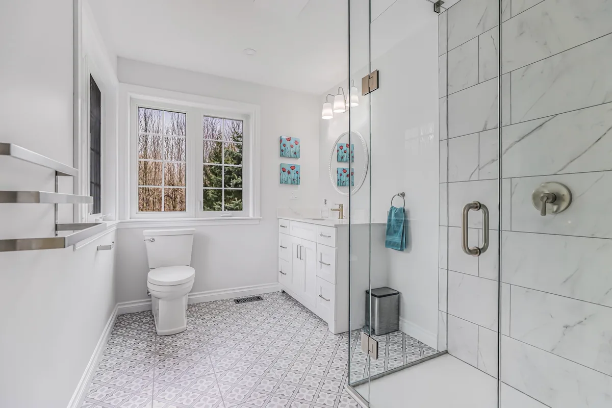 Completed ensuite with painted walls and ceiling beside a tiled shower
