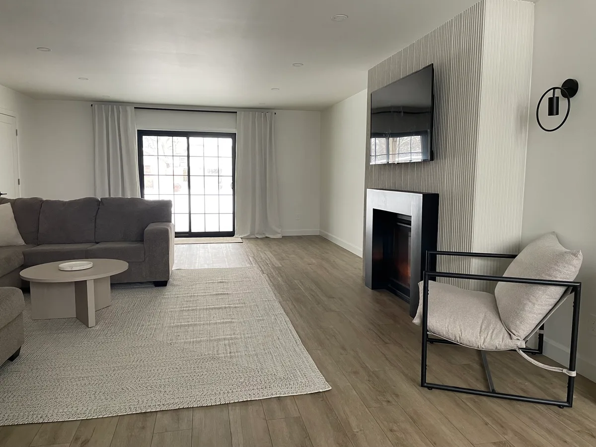 Completed living room with painted walls, ceiling and recessed lighting