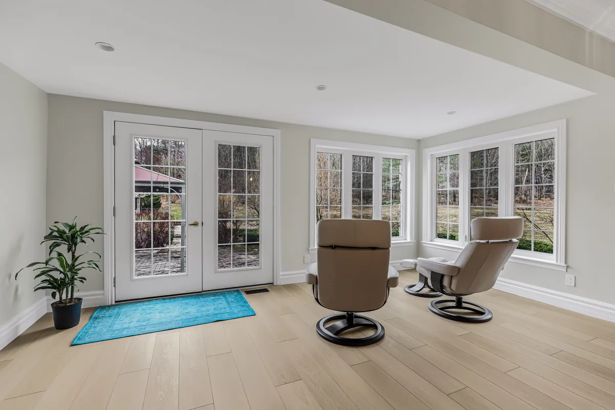 Finished sitting area with painted walls and ceiling around tall windows